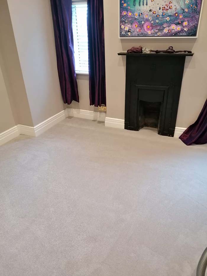 Fresh light grey carpet in a small living room