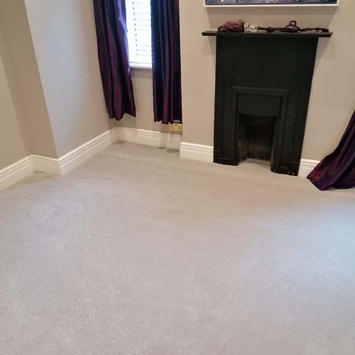 Fresh light grey carpet in a small living room